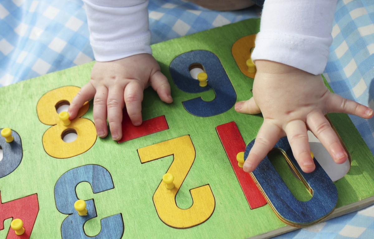 child playing with a number puzzle